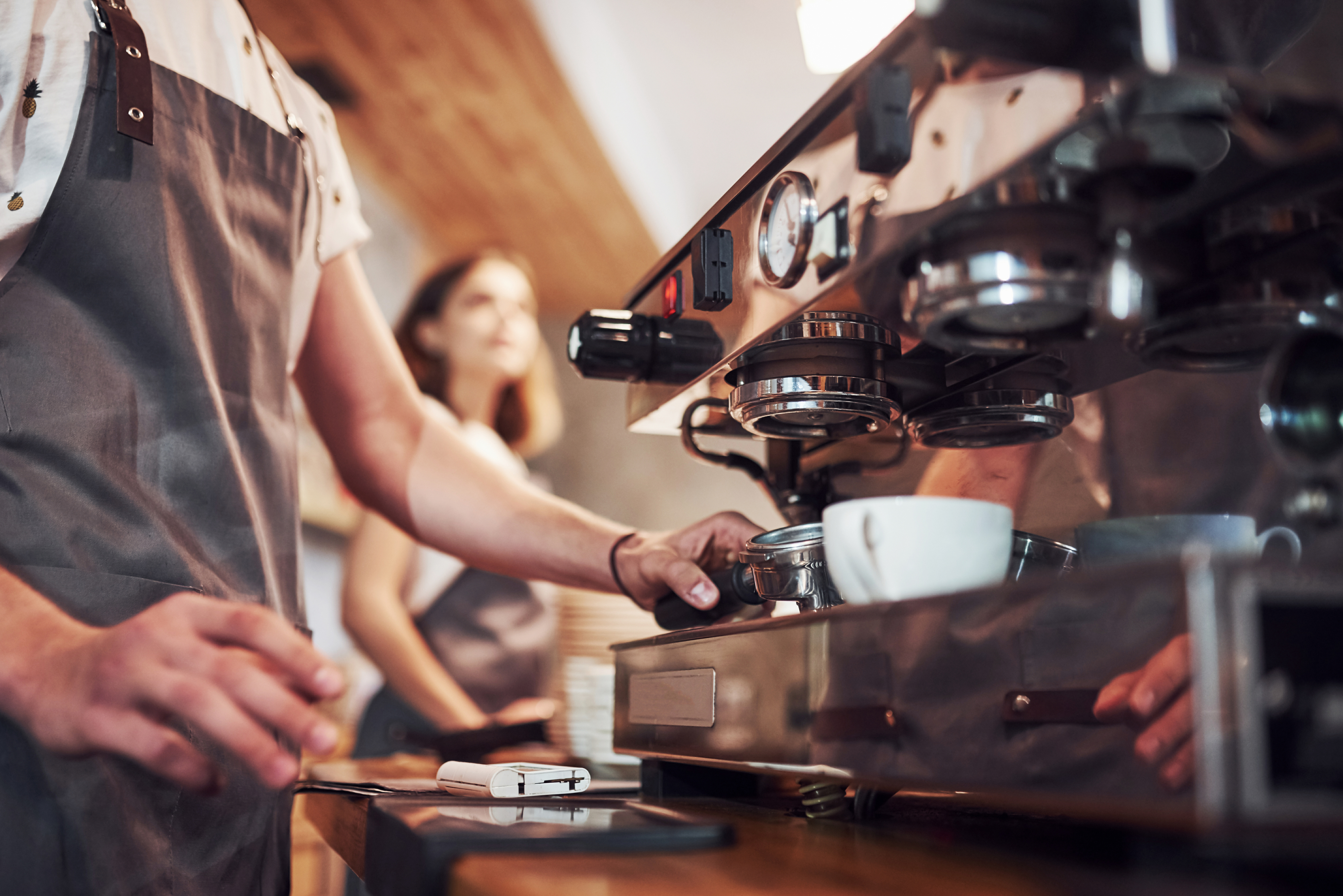 coffee shop with barista using coffee equipment